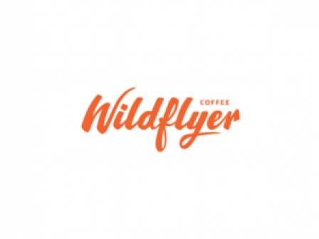 The image shows the "Wildflyer Coffee" logo in orange cursive text on a white background.